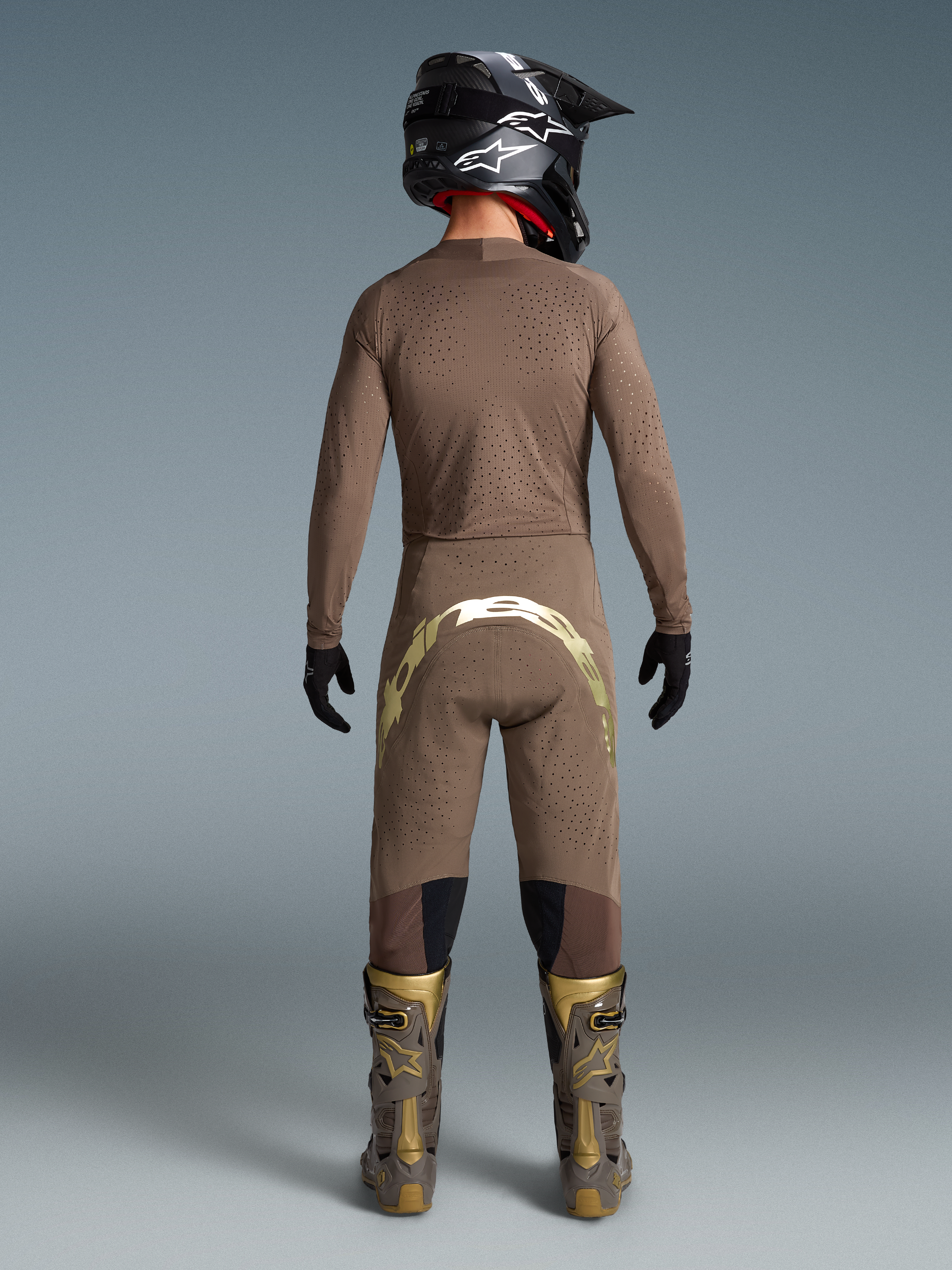 Alpinestars Limited Edition Supertech Air Gold motocross gear, men's brown and gold ventilated jersey, pants, and boots.