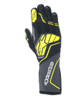 Alpinestars Tech-1 ZX V4 Gloves, Auto Racing Gloves, Tar Gray, Black and Yellow Fluo, featuring a large yellow star logo on the back and white branding on the cuff, honeycomb textured fabric with angular neon accents, professional motorsport gear.