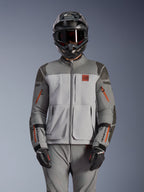 Alpinestars Nazca 3L GORE-TEX PRO Jacket, Adventure Motorcycle Jacket, Dark Gray and Mid Gray with orange zipper accents, worn with matching pants and black helmet, featuring durable textile construction with visible GORE-TEX PRO and All Terra branding