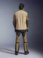Alpinestars Nazca 3L GORE-TEX PRO Jacket in Walnut Rock Brown, back view of rider, showing Superfabric reinforcements on elbows and rear ventilation zippers, worn with matching adventure pants, black boots, and gloves, rugged technical riding apparel for extreme adventure.