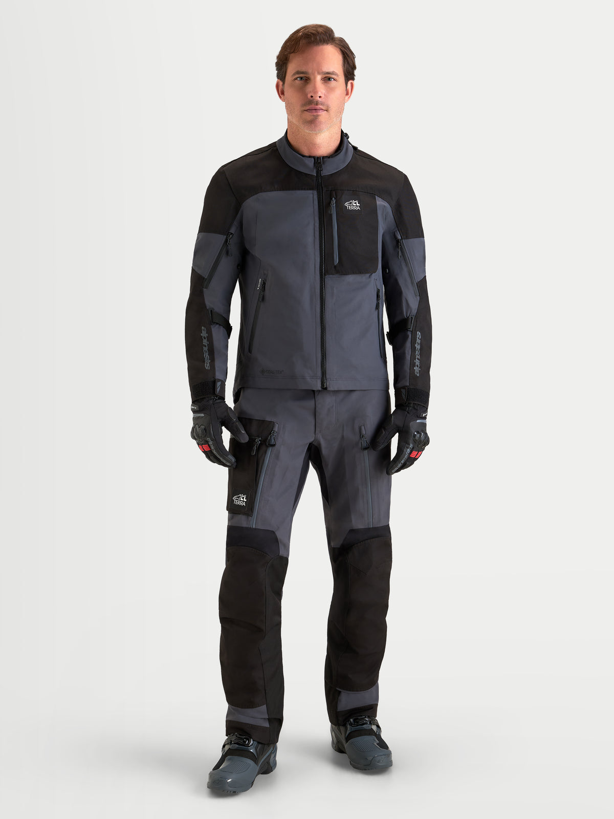 Alpinestars Arenis Gore-Tex Gear Set, men's adventure touring motorcycle jacket and pants in black and dark gray, full-length front view on a model wearing waterproof all-terrain riding apparel