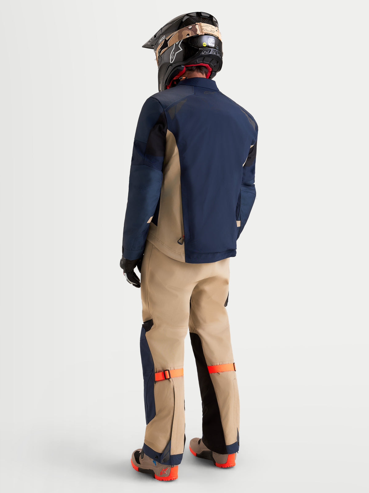 Alpinestars Arenis Gore-Tex Gear Set, men's adventure touring motorcycle jacket and pants in night navy and aluminum, rear profile view on a model wearing matching gear and helmet, waterproof textile construction for all-terrain riding.
