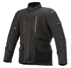 Alpinestars Ketchum GORE-TEX Jacket, Black motorcycle touring jacket, featuring a high collar, multiple zippered vents and large cargo pockets, adjustable straps on sleeves and waist, reinforced shoulder panels, and durable textile construction for adventure riding