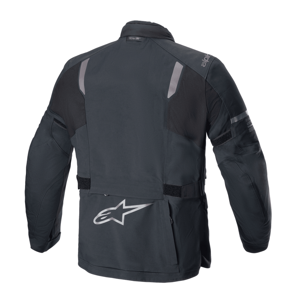 Alpinestars ST-7 2L GORE-TEX Jacket, Rear View, Black and Dark Gray, featuring reflective shoulder panels, silver Alpinestars star logo on the lower back, and adjustable waist straps, adventure touring motorcycle gear