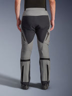 Alpinestars Nazca 3L GORE-TEX PRO Pants, Adventure Motorcycle Pants, Dark Gray and Black, back view, featuring zippered exhaust vents on thighs, calf volume adjusters, and reinforced seat panels, designed for extreme all-terrain riding.
