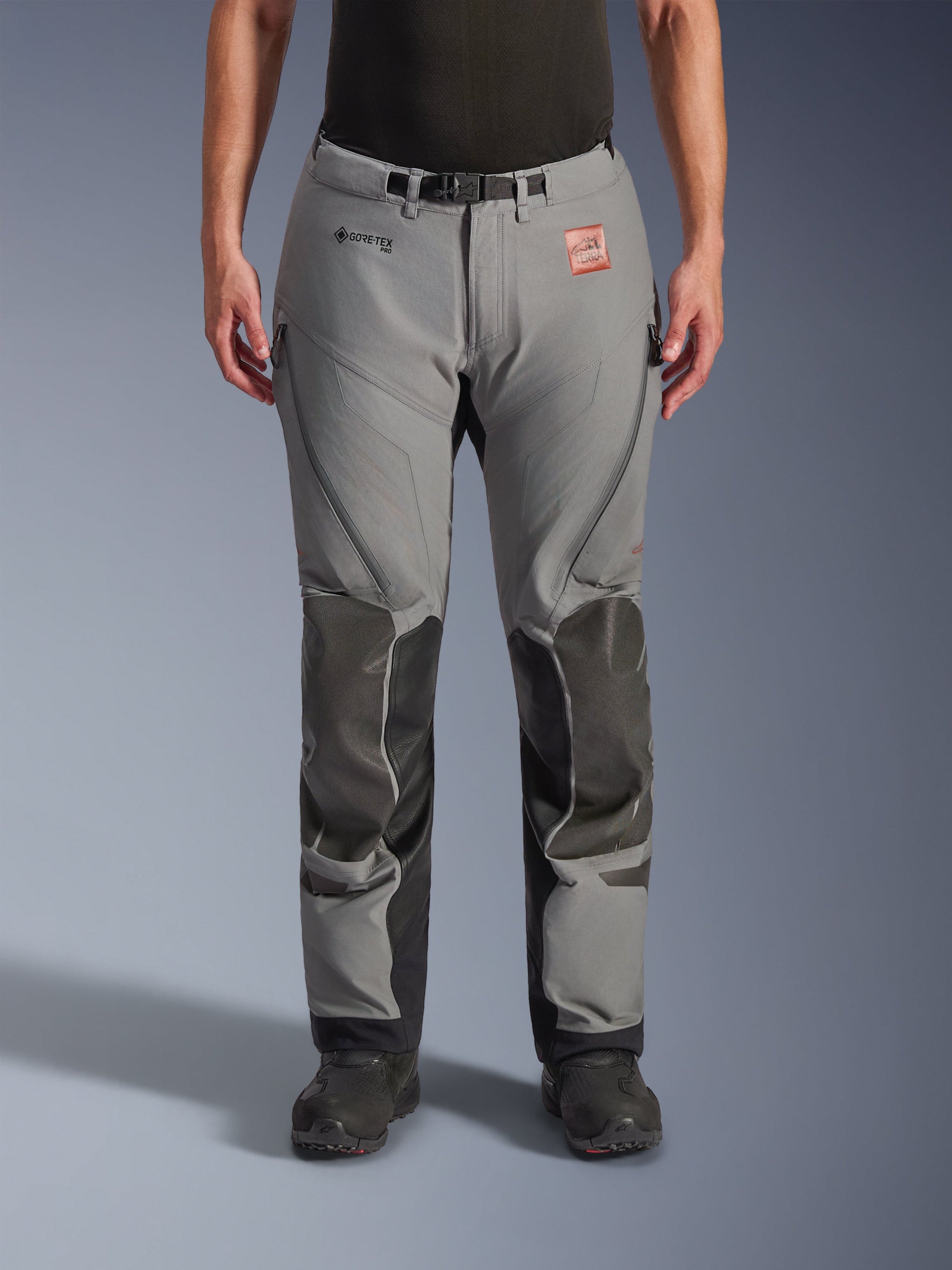 Alpinestars Nazca 3L Gore-Tex Pro Pants - Short, Adventure Motorcycle Pants, Dark Gray and Black, front view on model, featuring reinforced knee panels, GORE-TEX PRO branding, and TERRA leather patch, technical 3-layer waterproof construction for adventure touring