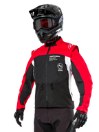 Alpinestars Pro-Dura Jacket, Off-Road Enduro Motorcycle Jacket, Black with Bright Red and White color blocking, worn by a rider with a black helmet and goggles, featuring front zippered pockets and Alpinestars branding, durable textile construction for trail riding
