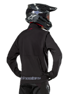 Alpinestars Lite-Dura Softshell Jacket, Black, back view worn by a rider, featuring gray Alpinestars branding on the rear hem and a small red logo on the collar, paired with a black motocross helmet, designed for enduro and off-road riding.