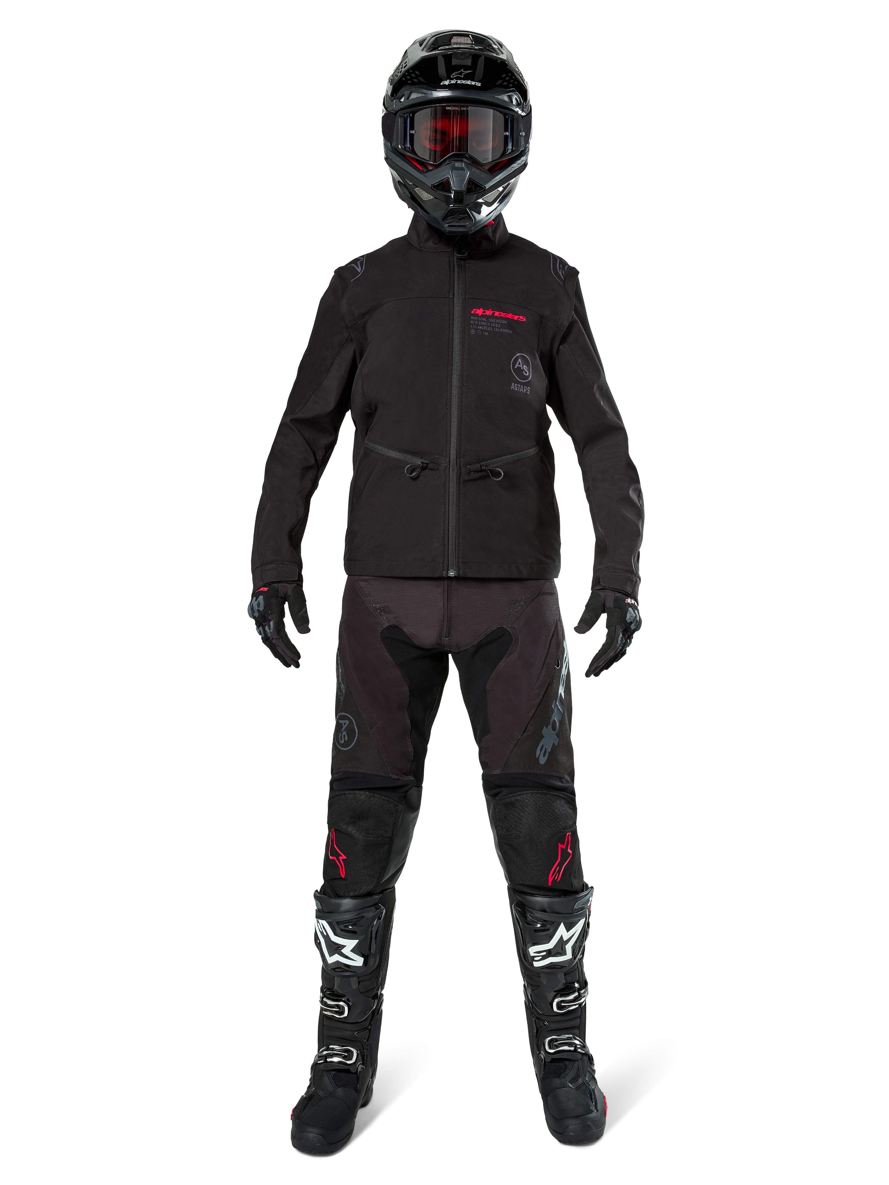 Motocross rider wearing the Alpinestars Lite-Dura Softshell Jacket in Black with red logo details, styled with matching black off-road pants, black helmet, and white and black boots, complete professional enduro racing gear.