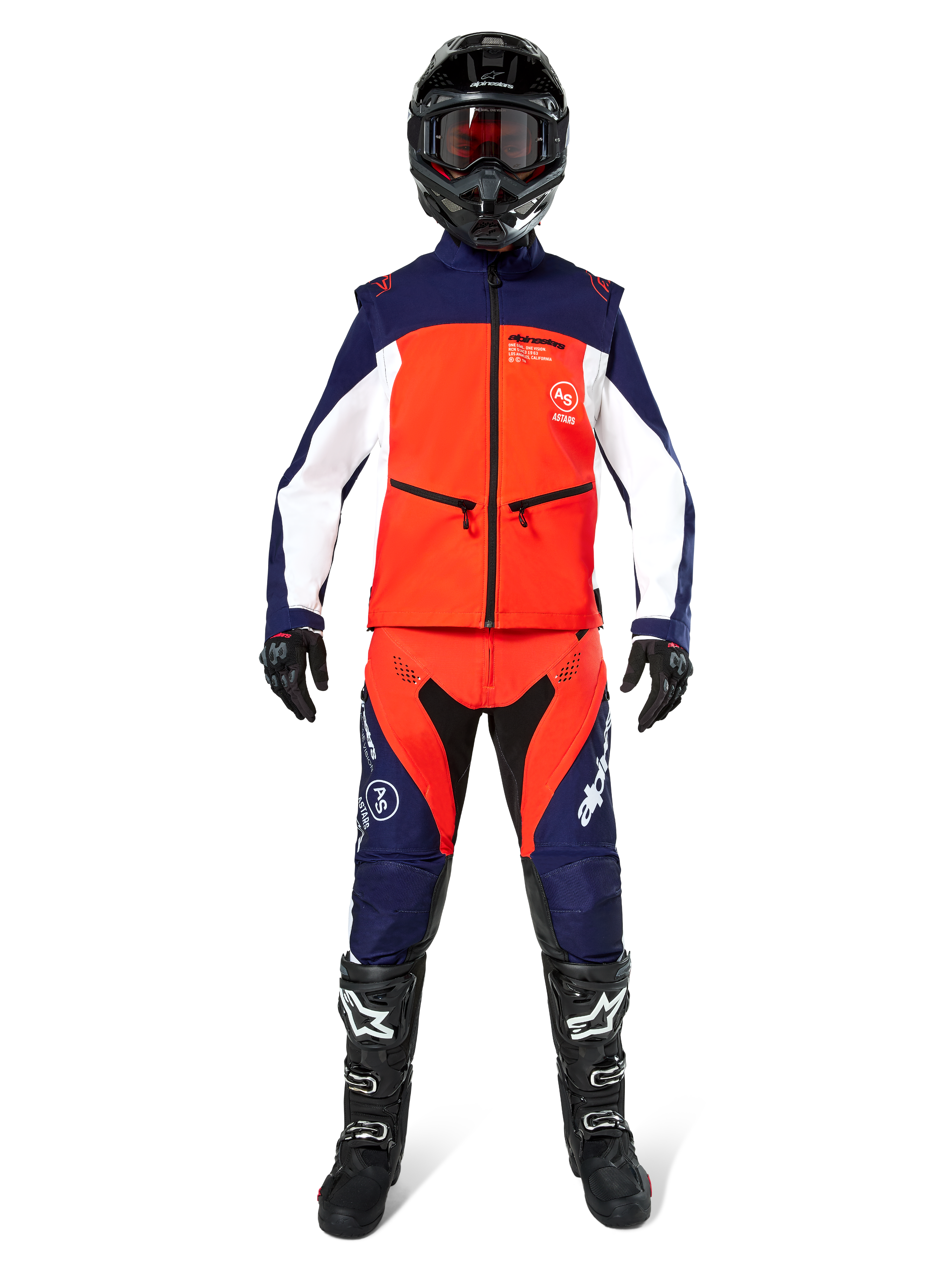Motocross rider wearing complete off-road gear, Lite-Dura Softshell Jacket in Navy Hot Orange and White, matching navy and orange pants, black helmet with goggles, black and white boots, black gloves, coordinated outfit for enduro racing