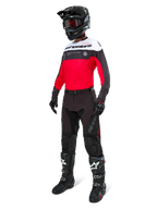 Alpinestars Pro-Dura Pants in Black Magnet White, worn by a rider with a matching red, black and white jersey, black helmet, and black off-road boots, complete professional enduro racing gear set for off-road performance.