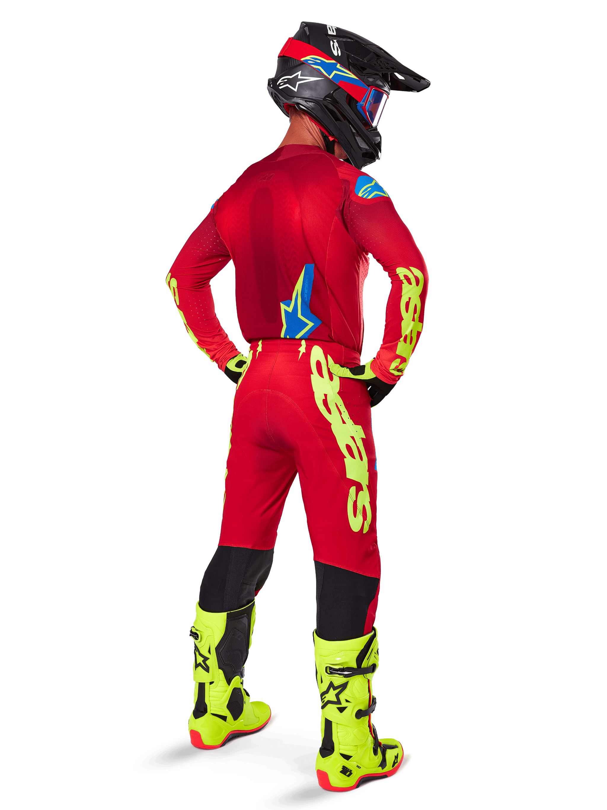 Alpinestars 2025 Supertech Maker Pants, Motocross Pants, Bright Red and Yellow Fluo, seen from behind on a rider wearing a matching red jersey, fluorescent yellow boots, and black helmet, featuring large yellow Alpinestars branding on the leg.