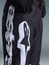 Alpinestars 2026 Racer Air Riway Pants, Motocross Pants, Black and White, close-up view showing large white Alpinestars branding, laser-cut perforations for airflow, and adjustable waist buckle, durable fabric for off-road riding.
