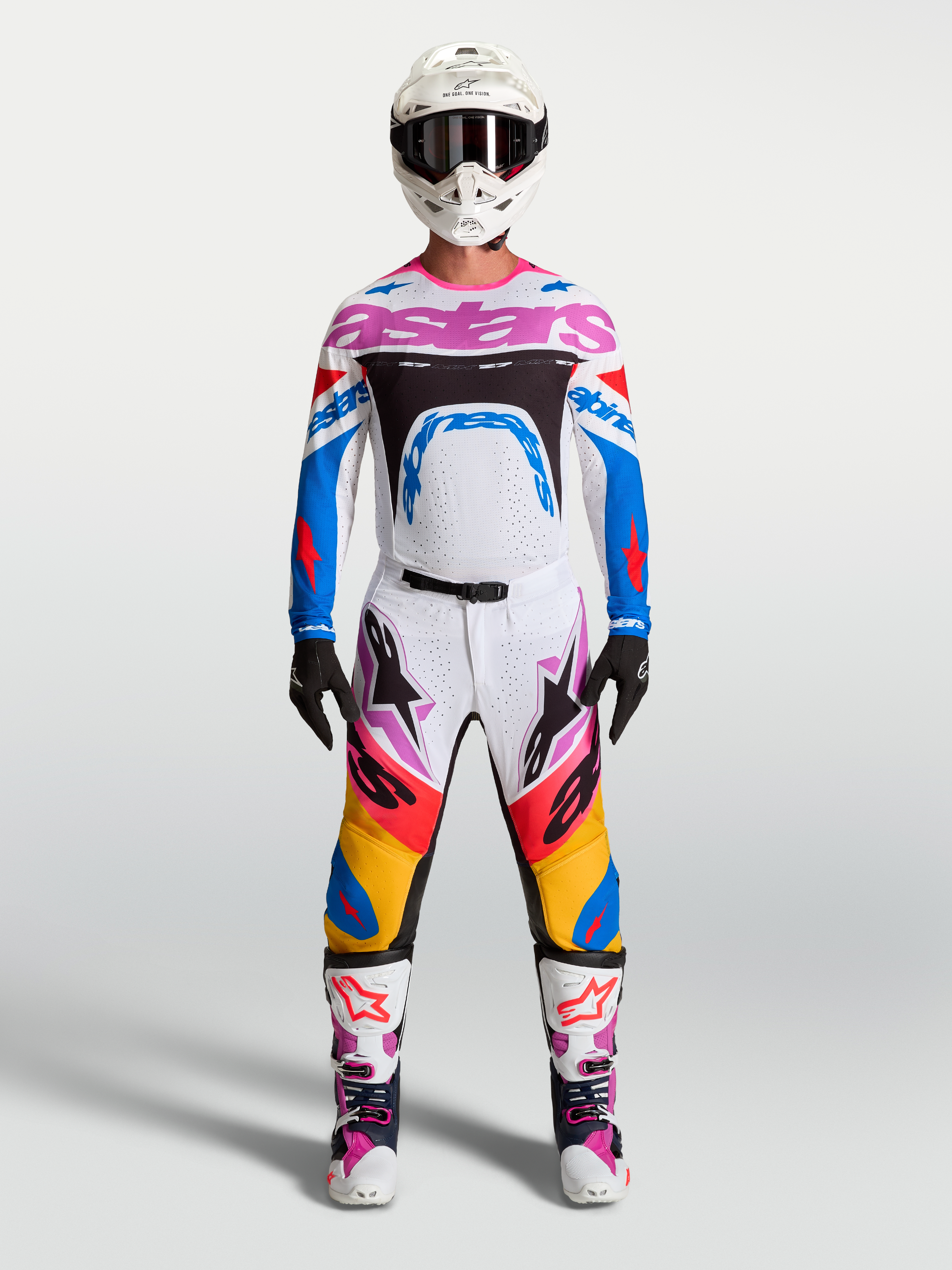 Alpinestars Supertech Dyna Pants and gear set, men's white and blue motocross racing outfit with pink accents.