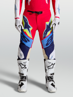 Alpinestars Supertech Dyna Pants, Motocross Racing Gear for Men, Fire Red and Navy Blue with White and Yellow accents, Featuring goat leather knee panels and magnetic buckle closure.