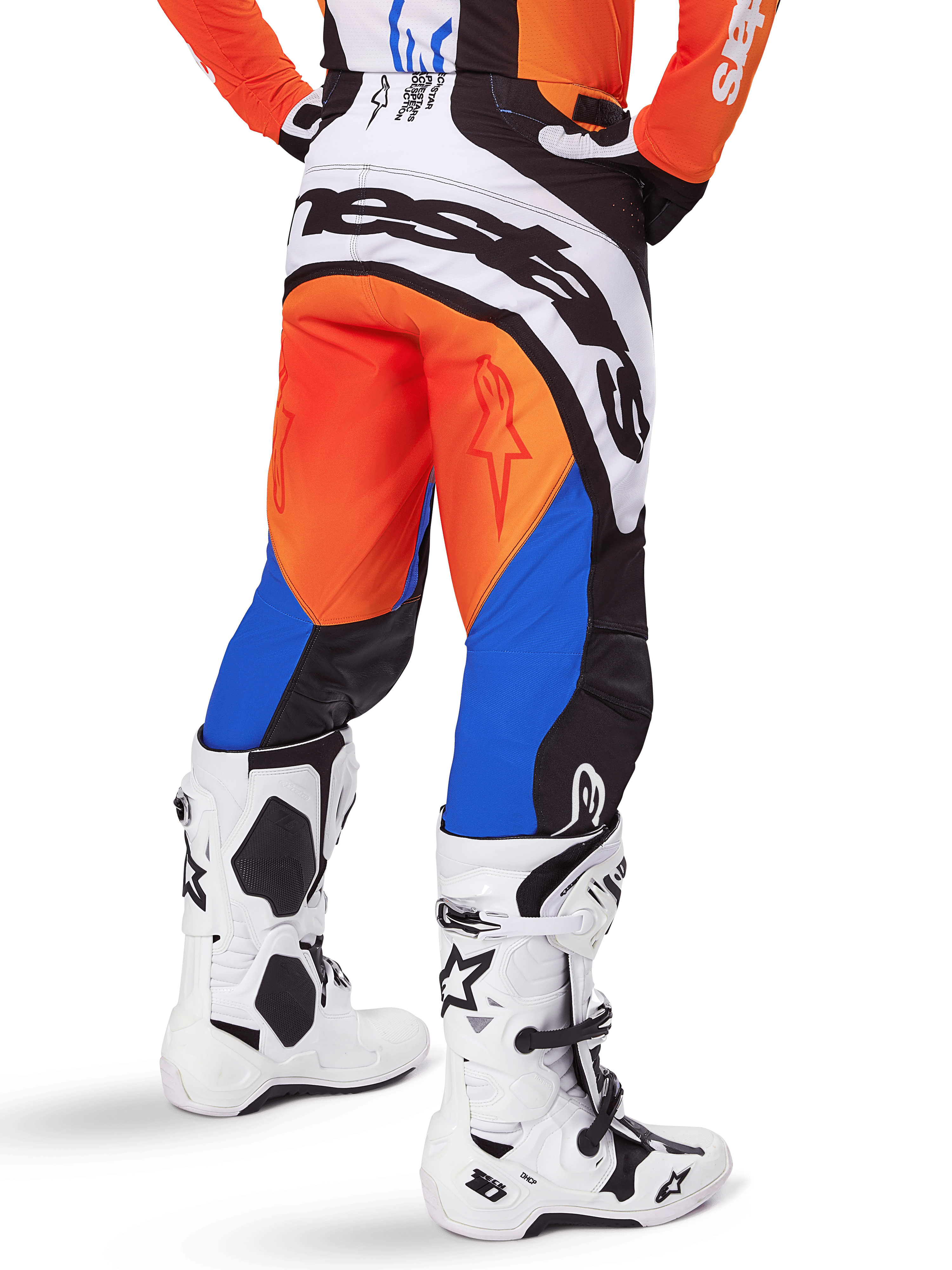 Alpinestars 2025 Techstar Melt Pants, Motocross Pants, Orange and Blue, viewed from behind, featuring large white branding on the seat, worn with matching orange jersey and white Tech 10 boots, durable off-road racing gear