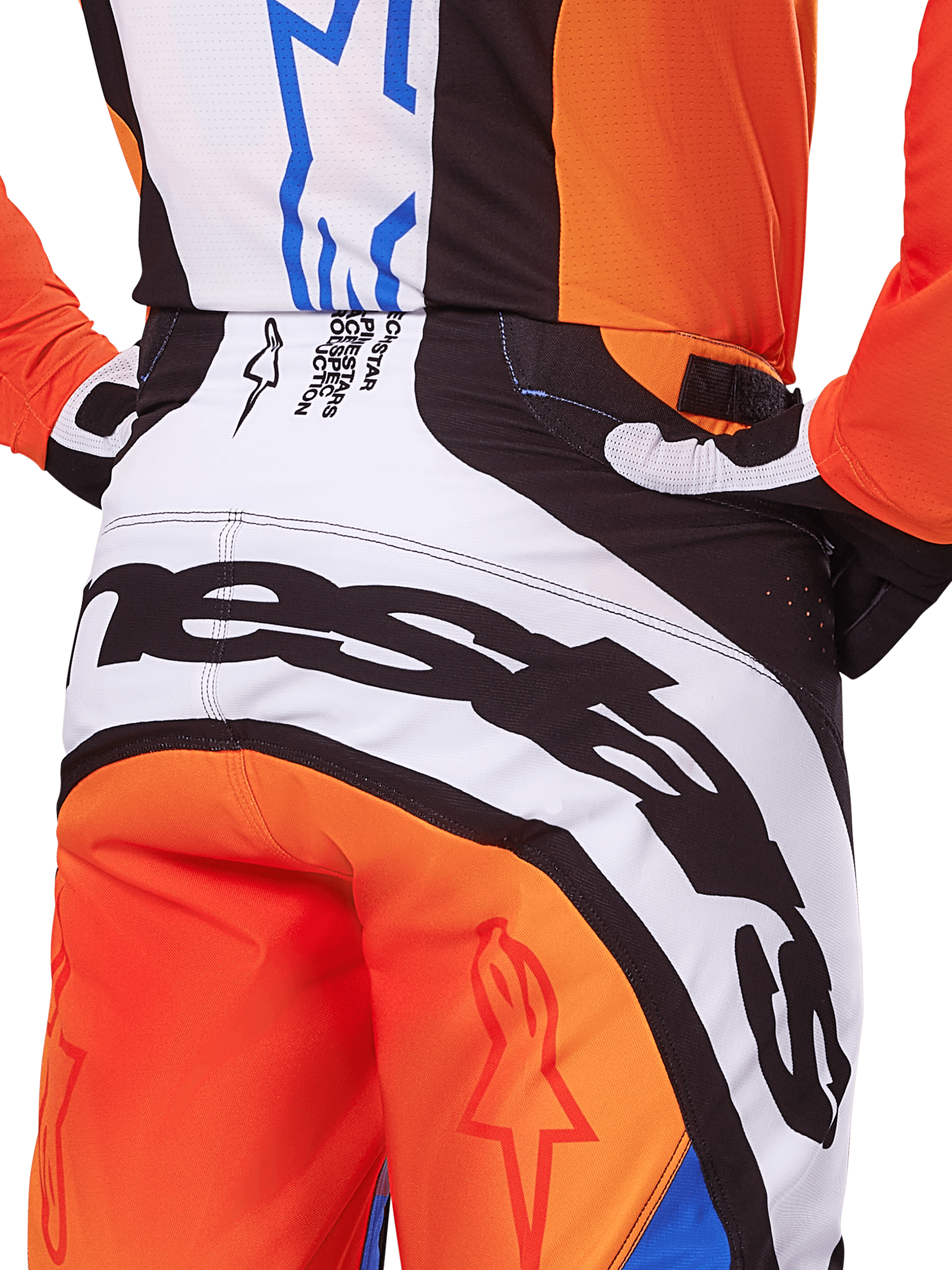 Alpinestars 2025 Techstar Melt Pants, Motocross Pants, Orange and Blue, close-up rear view of the seat and waistband, bold black branding on white background, orange panels with red star logos, athletic performance gear for off-road racing