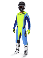 Alpinestars 2025 Techstar Melt Pants, Motocross Pants, Yellow Fluo and Blue, worn as part of a complete racing gear set with matching jersey, yellow and black gloves, white and black boots, and black helmet with white goggles, coordinated off-road performance gear.