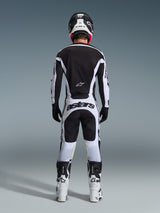 Alpinestars 2026 Racer Riway Pants, Motocross Pants, White and Black, rear view of complete racing gear set, bold 'astars' branding on the seat, worn with matching jersey, white boots, and black helmet, coordinated off-road racing outfit.