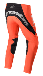 Alpinestars 2023 Supertech Risen Pants, Motocross Pants, Hot Orange and Black, rear view featuring bold silver branding on the seat, black inner leg panels, and perforated ventilation zones for off-road racing.