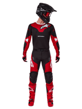 Alpinestars 2025 Racer Veil Pants, Motocross Pants, Black and Bright Red, worn as part of a complete racing gear set with matching jersey, black helmet, red goggles, and red boots, featuring bold white Alpinestars logos and athletic design for off-road performance.