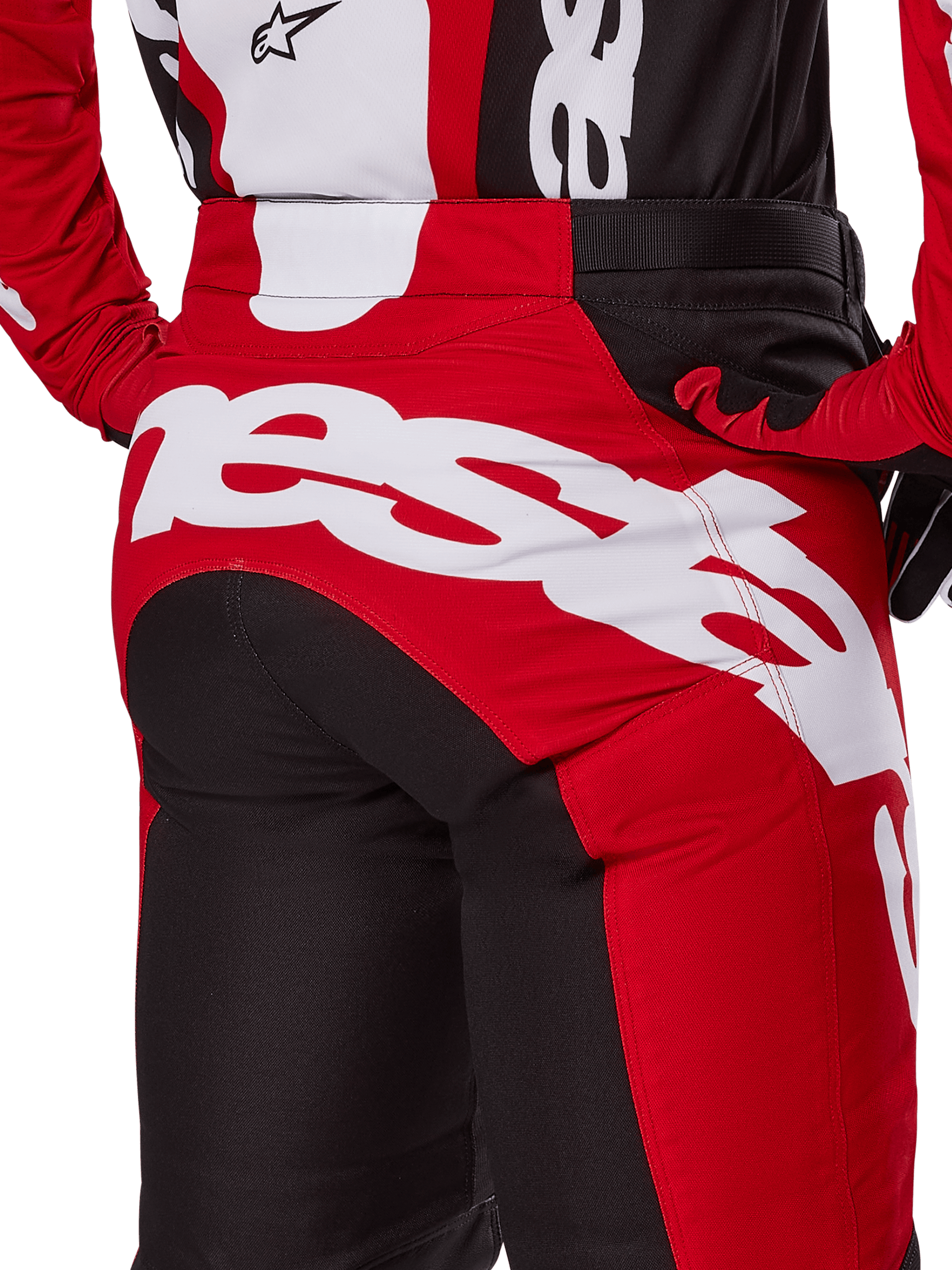 Alpinestars 2025 Racer Veil Pants, Motocross Pants, Black and Bright Red, close-up view of the rear seat area featuring large white Alpinestars wordmark logo, red and black technical panels, worn with matching gear