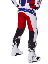 Alpinestars 2025 Racer Veil Pants, Motocross Pants, Bright Red and White with Blue branding, rear view showing black stretch ventilation panels on the back of the legs, paired with white motocross boots.