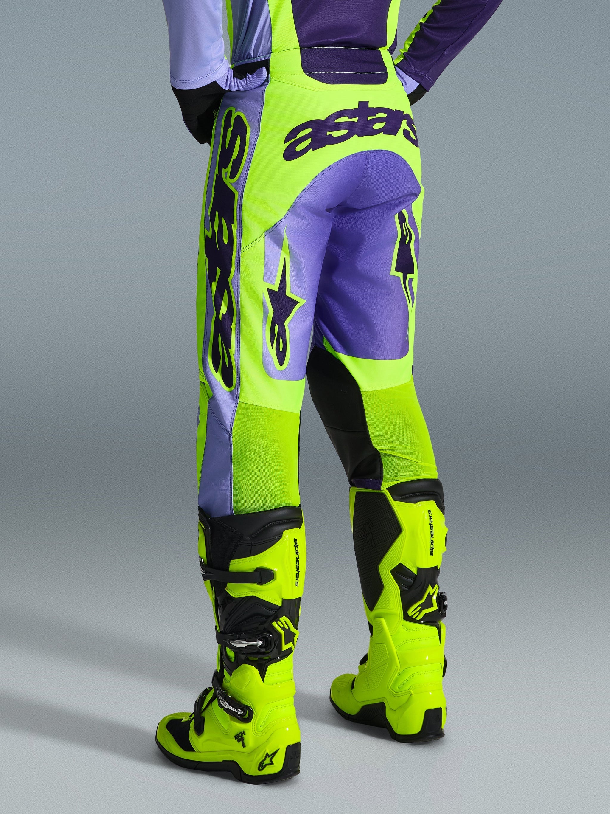 Alpinestars 2026 Racer Portl Pants, Motocross Pants, Purple and Yellow Fluo, back view featuring bold astars branding and purple accents, worn with matching fluo yellow motocross boots, durable synthetic material for off-road racing