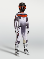 Alpinestars Techstar Swan Motocross Gear Set, men's racing pants and jersey in Light Lilac and Red Fluo with white boots.