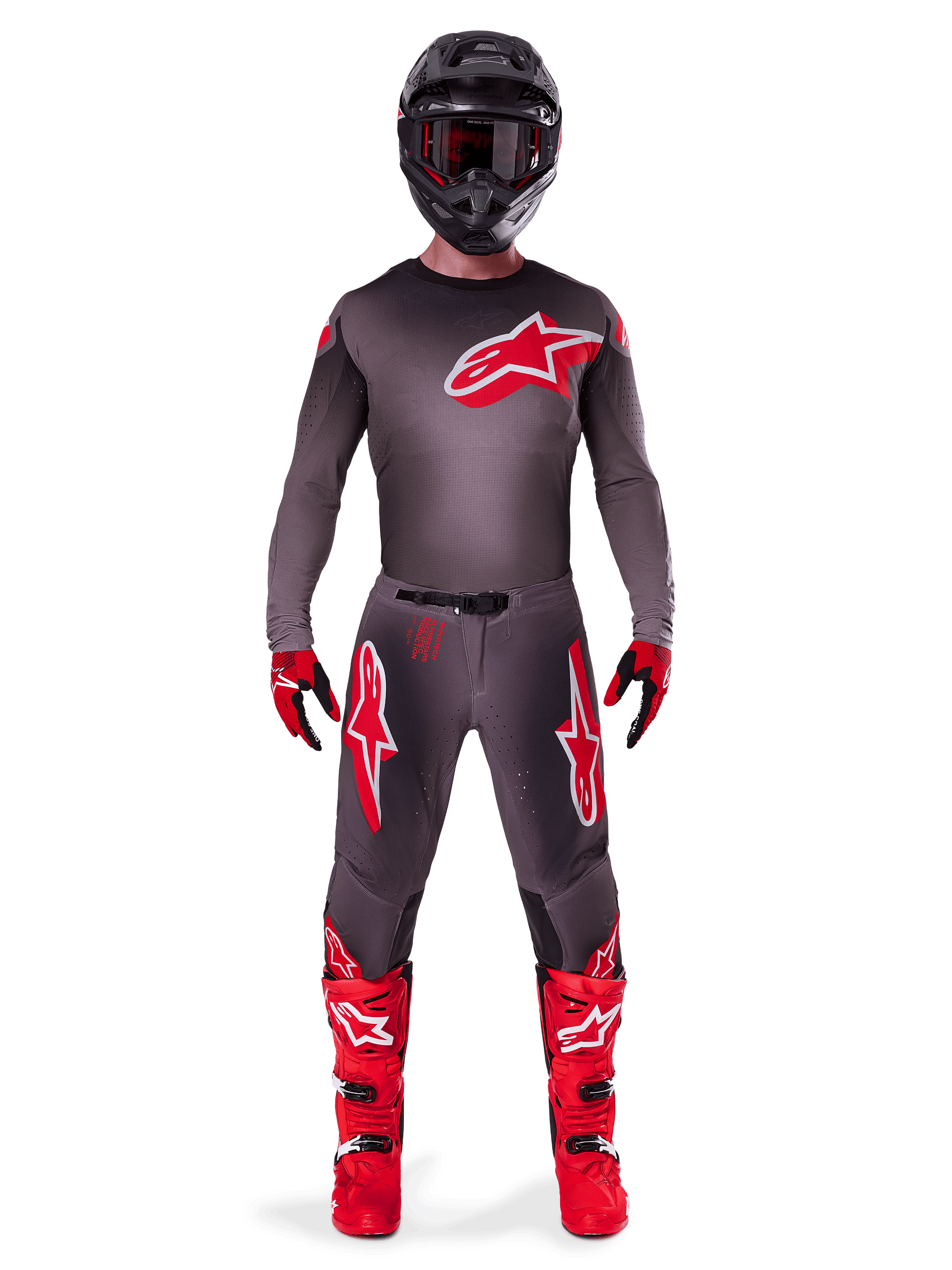 Motocross rider wearing complete Alpinestars 2025 Supertech Lipan gear set, Smoke Bright Red, featuring a dark grey jersey and pants with prominent red logos, black helmet with goggles, red and black gloves, and vibrant red motocross boots, coordinated professional racing outfit