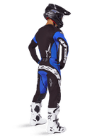 Alpinestars 2025 Techstar Dreem Pants, Motocross Pants, Black and Blue, worn by a rider in a full gear set including a matching jersey, black helmet, and white boots, featuring bold white branding on the rear and a performance-driven racing fit.