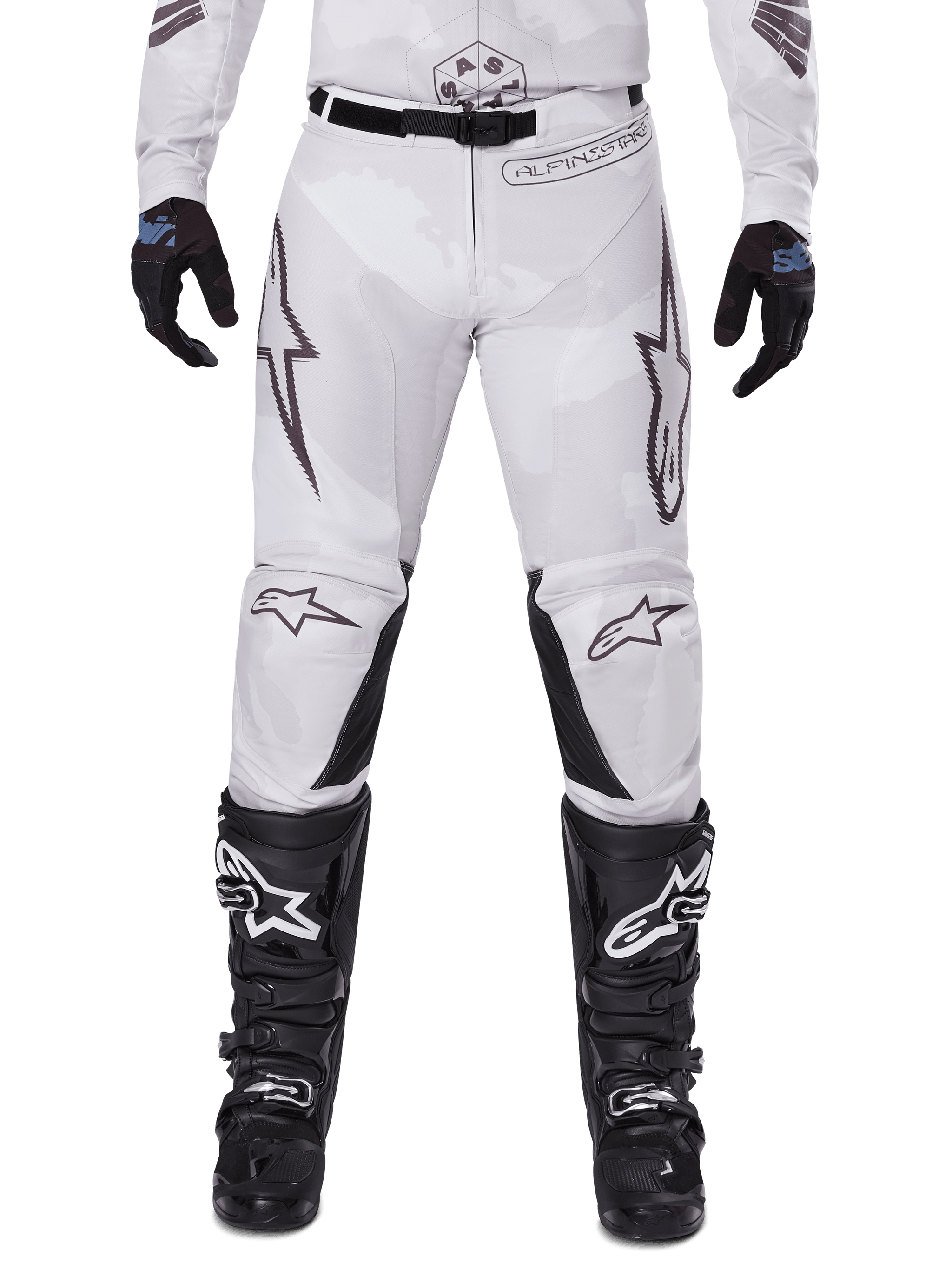 Alpinestars 2025 Racer Hollow Pants, Motocross Pants, Light Camo Brown, worn with black gloves and motocross boots, featuring a subtle camo pattern with black graphic prints and Astars logos, ergonomic design for performance off-road riding