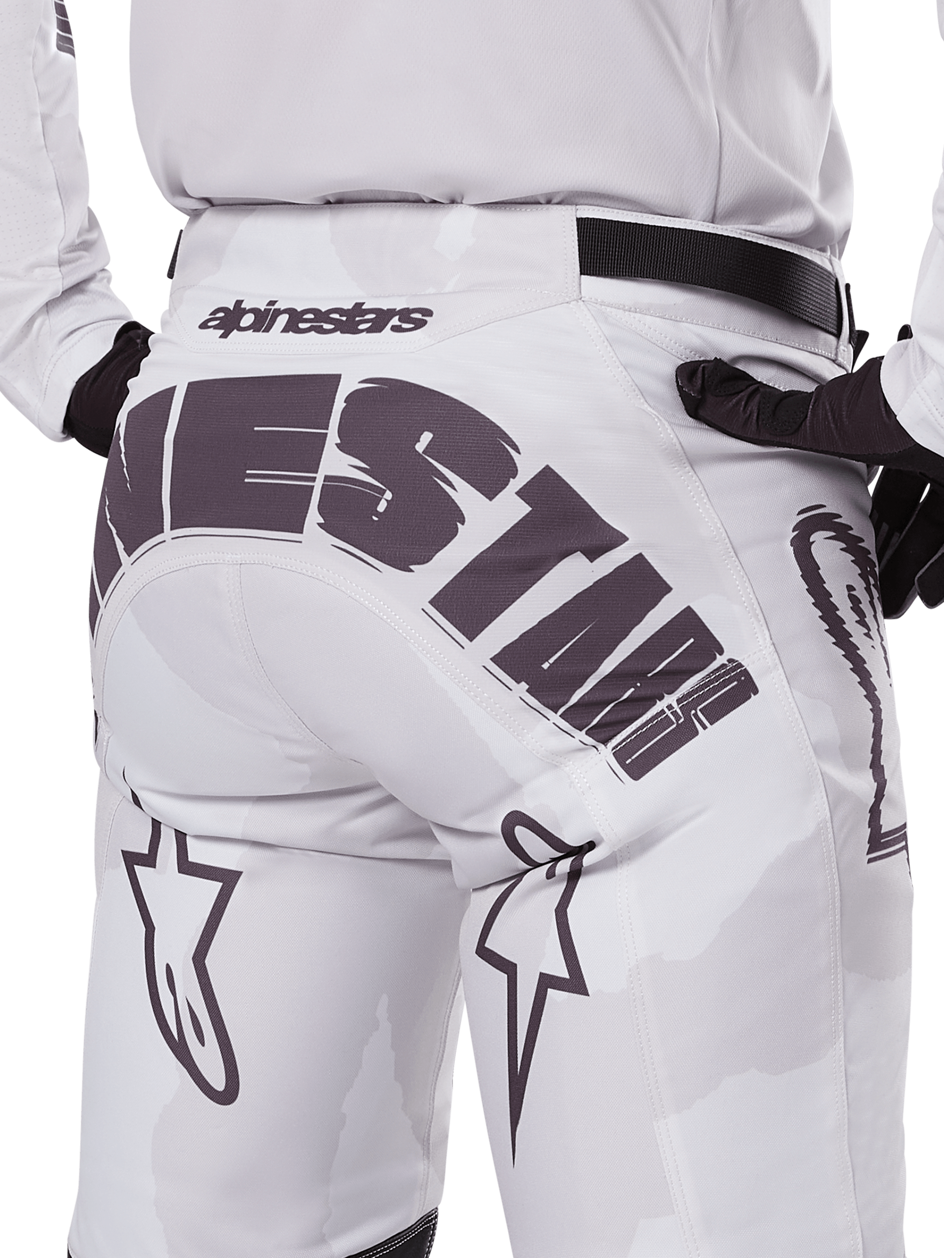 Rear view of Alpinestars 2025 Racer Hollow Pants, Motocross Pants, White and Light Camo, featuring bold black Alpinestars branding on the seat, worn with a matching jersey and black gloves
