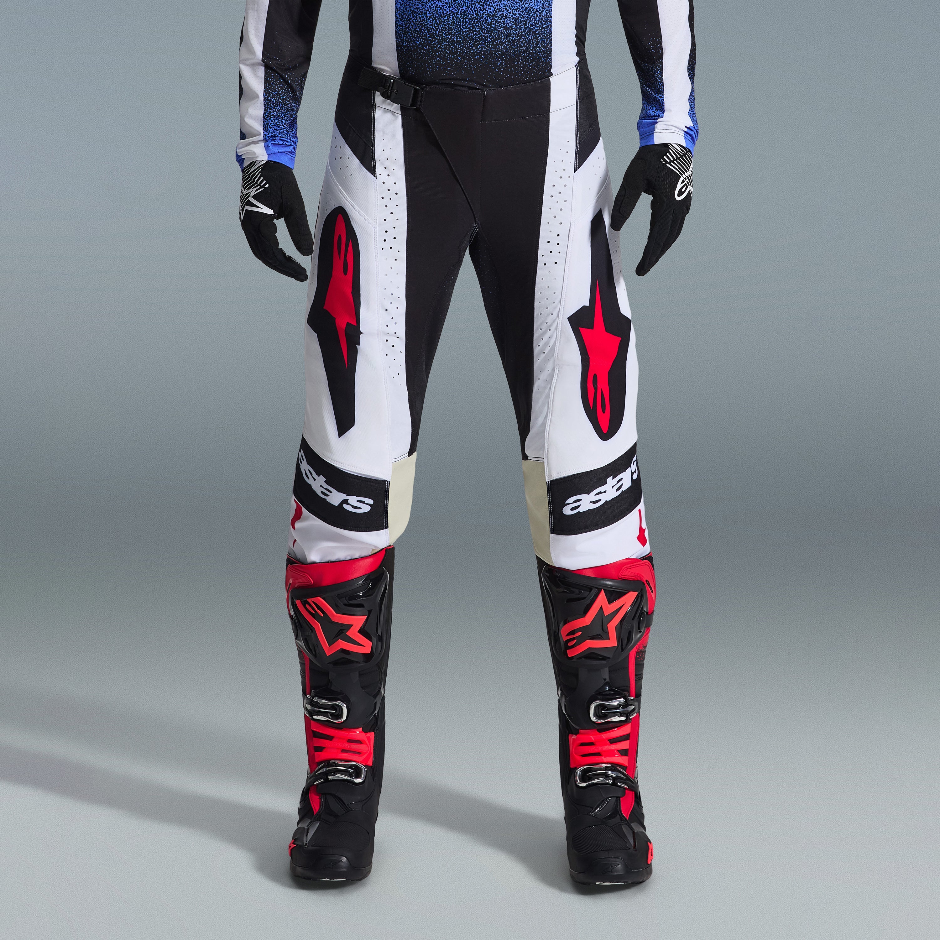 Alpinestars 2026 Techstar Knif Gear Set, Motocross gear, Black and White pants with large Red star logos, worn with black and red racing boots and black gloves, professional athletic fit for off-road performance