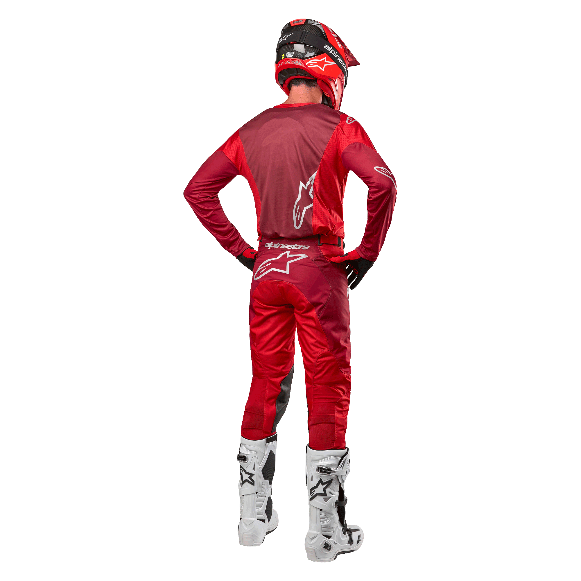 Alpinestars 2024 Racer Hoen Pants and matching jersey in Mars Red Burgundy, rear view of a motocross rider in full gear including a red helmet and white boots, showcasing the athletic fit and branding for off-road racing.