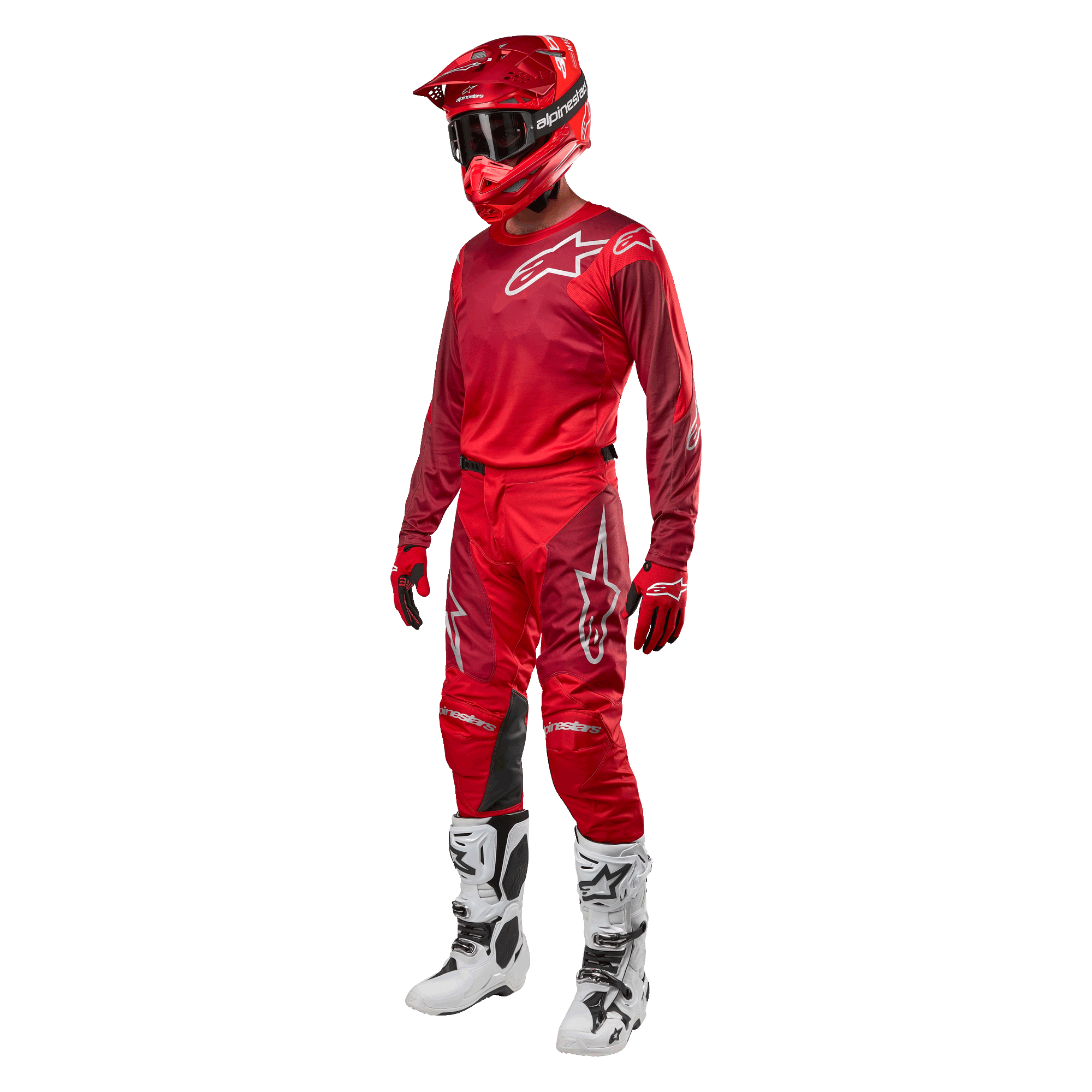 Motocross rider wearing complete racing gear, Alpinestars 2024 Racer Hoen Pants and jersey in Mars Red Burgundy, red helmet, red gloves, and white and black boots, coordinated outfit for off-road racing