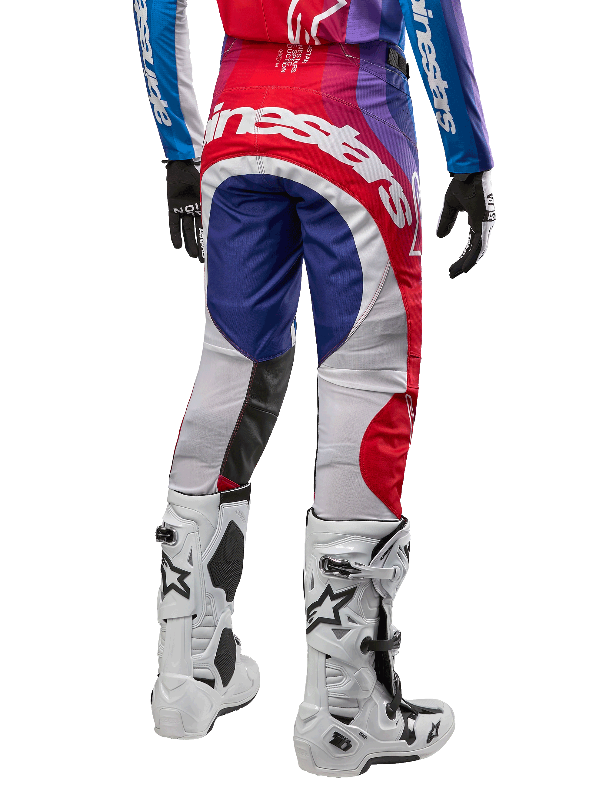 Alpinestars 2024 Techstar Pneuma Pants, Motocross Pants, Blu Mars Red White, rear view worn with matching jersey and white boots, featuring bold white branding on the seat and multi-color paneling, professional motocross racing apparel