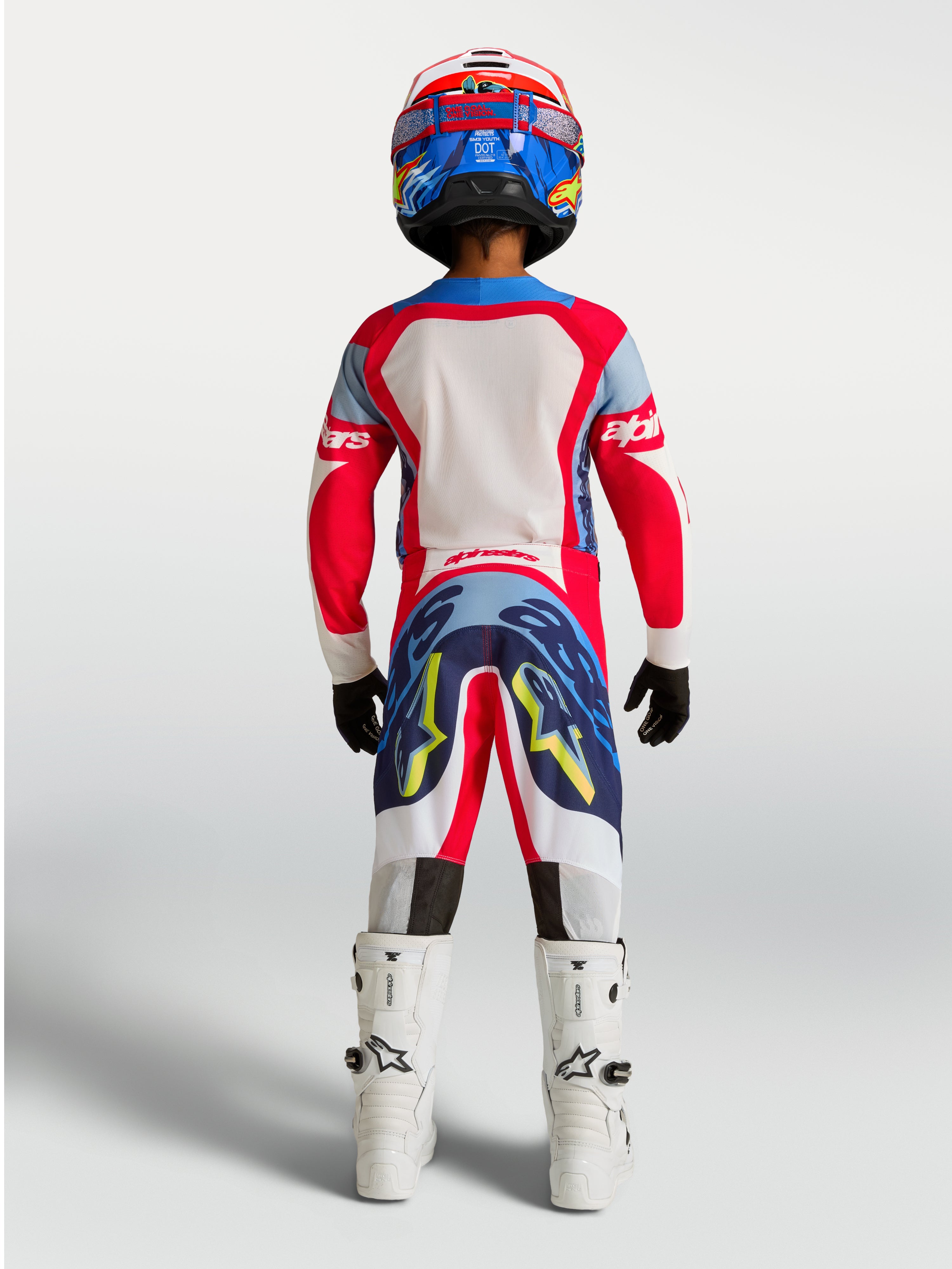 Alpinestars Youth Supertech Dyna Pants, red and navy blue motocross gear for young riders, rear view on-model.