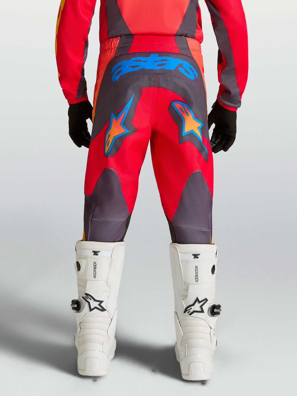 Alpinestars Youth Fluid Hunt Pants, Red and Graystone motocross pants with durable 600D seat and blue star graphics.
