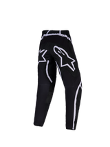 Alpinestars 2026 Youth Fluid Apex Pants, Motocross Pants, Black and White, rear view featuring large white star logos on the seat and curved graphic accents, technical off-road riding gear for youth