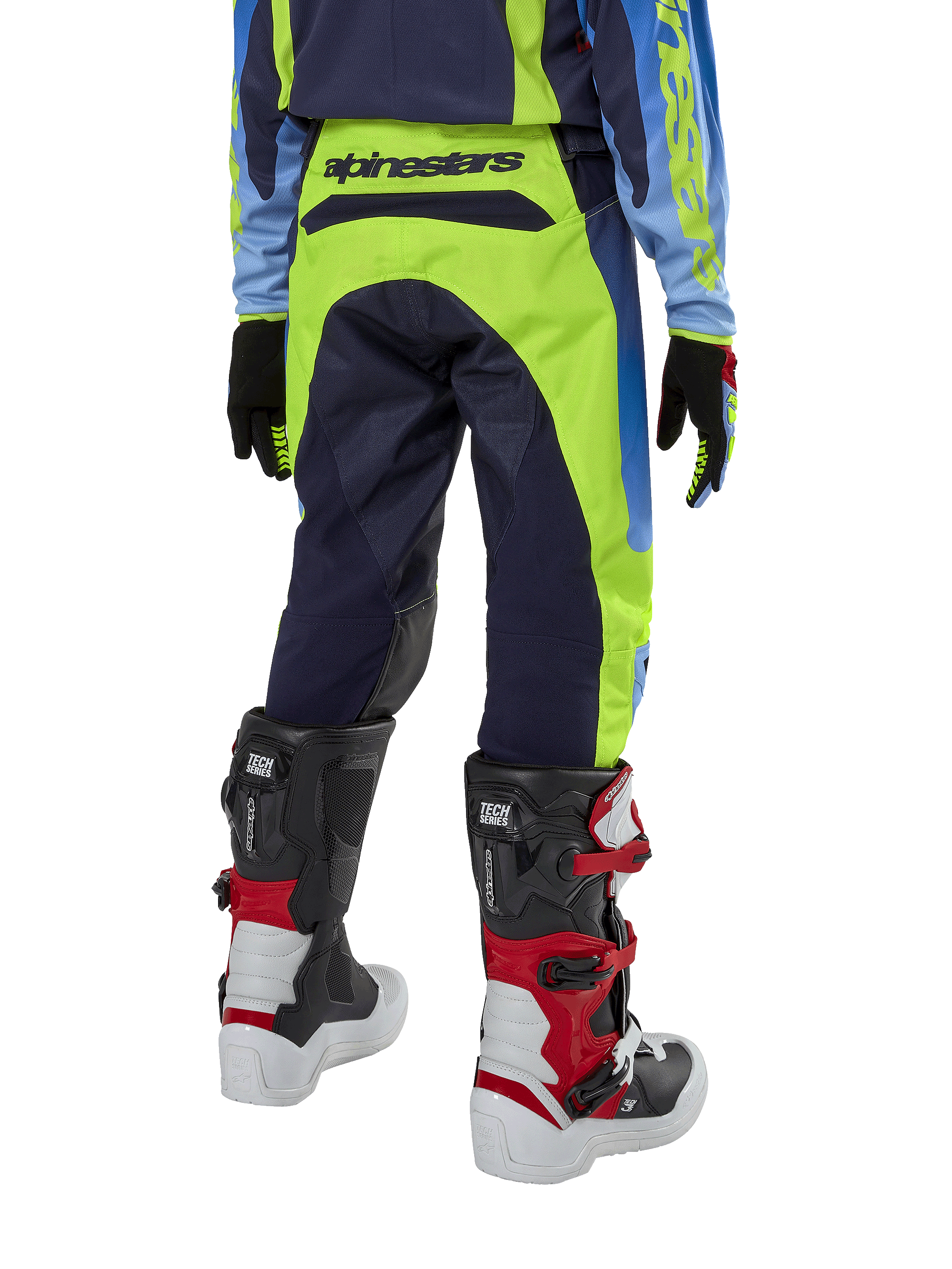 Alpinestars Youth 2024 Racer Hoen Pants, Motocross Pants, Yellow Fluo and Blue Night Navy, rear view showing bold Alpinestars branding on the waistband, worn with black and red Tech Series boots and coordinating jersey, durable sport fit for youth off-road riding