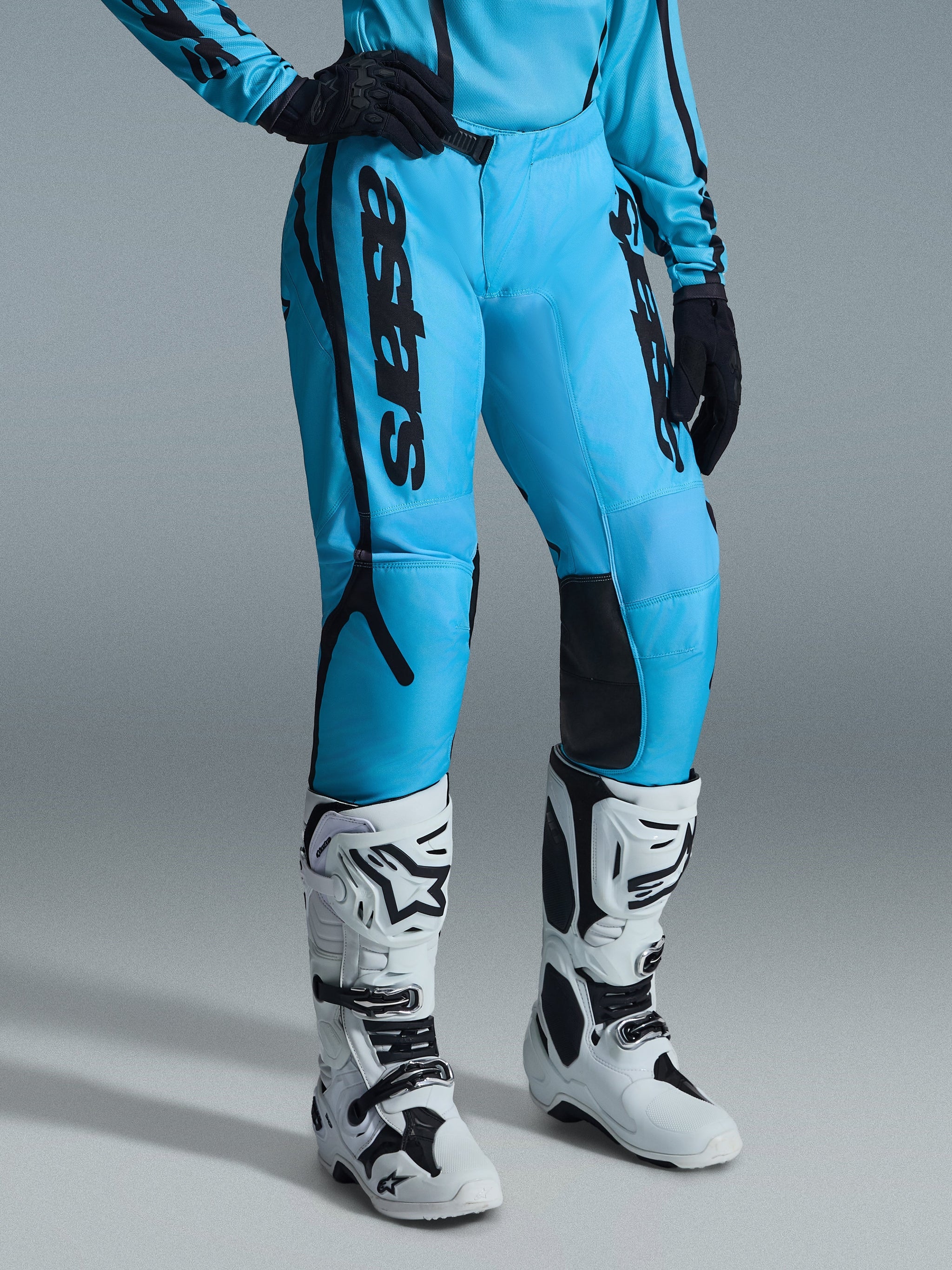 Alpinestars 2026 Woman Stella Fluid Apex Pants, Motocross Pants, Bright Blue with Black branding, worn with matching jersey, black gloves, and white and black off-road boots, ergonomic design for performance riding