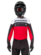 Alpinestars Pro-Dura Jersey, Motocross Jersey, Black Bright Red and White, worn with black helmet and goggles, sporty design with bold Alpinestars branding and laser perforations, performance enduro and off-road racing gear