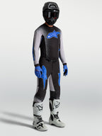 Alpinestars Supertech Hiten AFD Jersey and Gear Set, black and blue motocross kit with white racing boots.