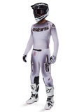 Alpinestars 2025 Supertech Maker Gear Set, complete motocross outfit, white and grey gradient with black branding and red accents, includes helmet with goggles, jersey, pants, white boots, and gloves, sleek performance-driven design for off-road racing