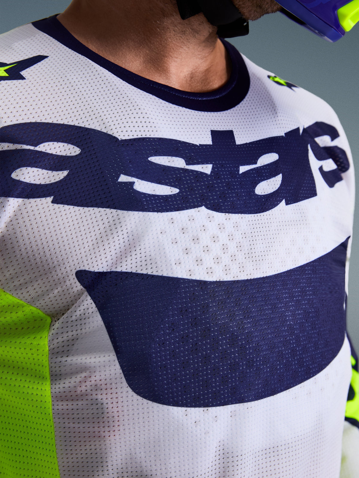 Alpinestars 2026 Racer Air Riway Jersey, Motocross Jersey, Light Gray and Navy Blue with Fluorescent Yellow, close-up of chest showing 'astars' logo and perforated mesh fabric, athletic fit for off-road riding