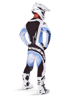 Motocross rider wearing complete racing gear, 2025 Techstar Melt Gear Set, White and Light Blue jersey with black back panel, matching pants with blue gradient and black accents, white helmet, white and black boots, coordinated outfit for off-road racing