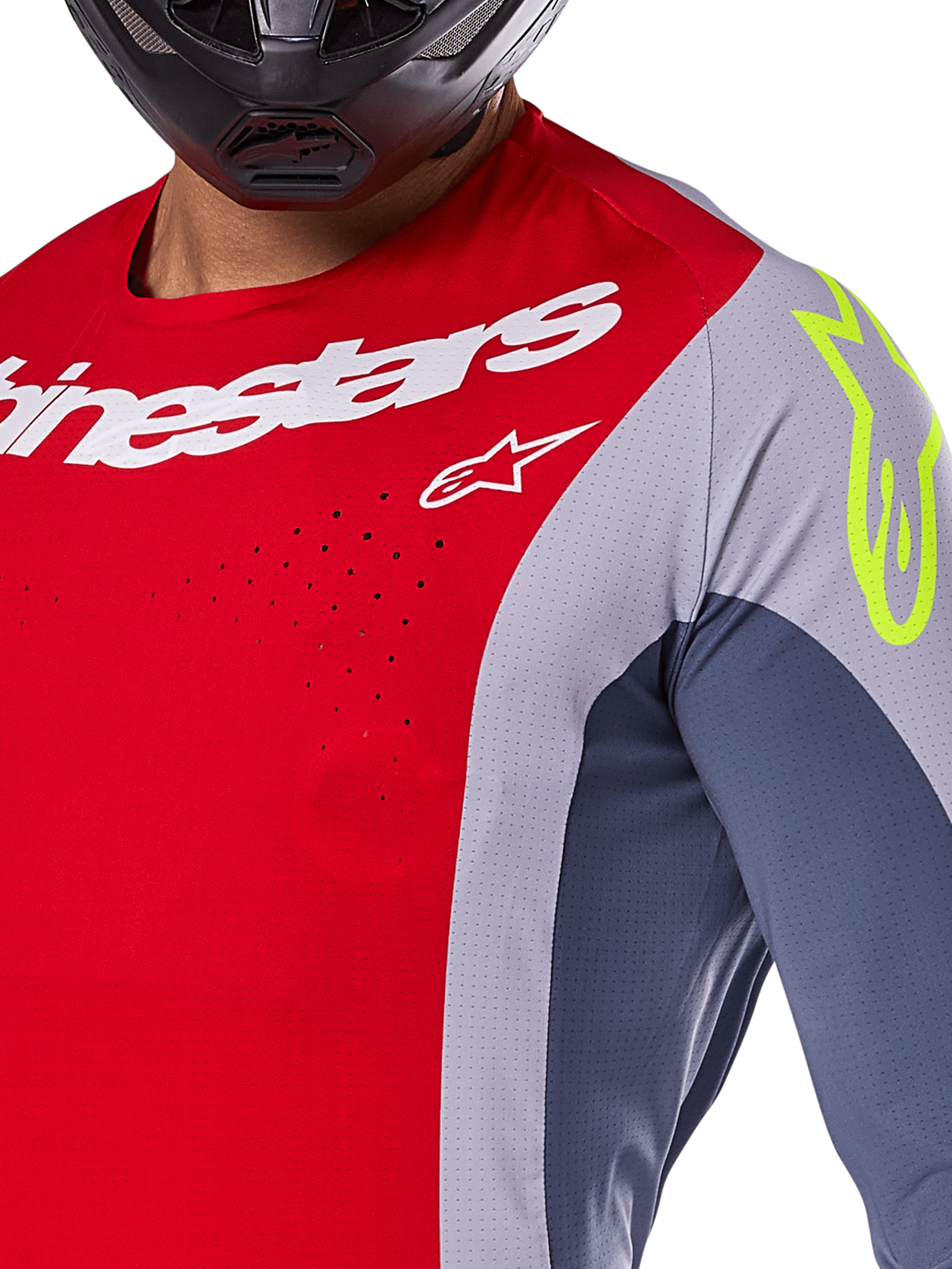 Alpinestars 2025 Techstar Melt Jersey, Motocross Jersey, Bright Red and Gray with dark blue panels, featuring white Alpinestars branding and a neon yellow logo on the shoulder, close-up showing laser-cut ventilation perforations and a black helmet.