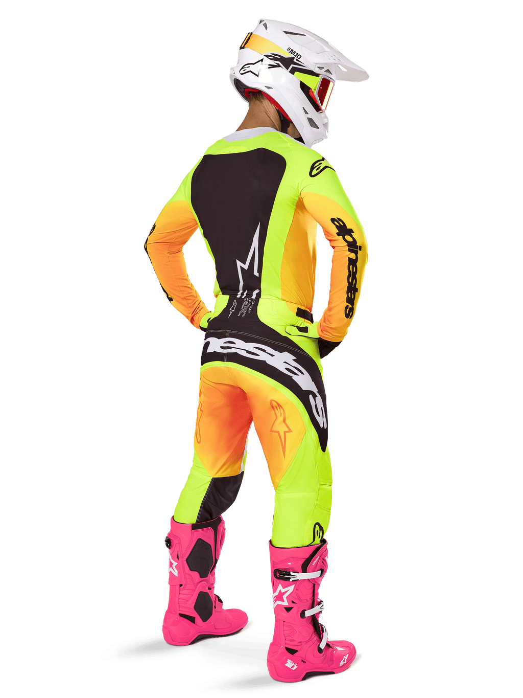 Motocross rider from the back wearing Alpinestars 2025 Techstar Melt Jersey, vibrant yellow and orange gradient with black sections, matching motocross pants, bright pink boots, and white helmet, athletic fit for off-road competition.