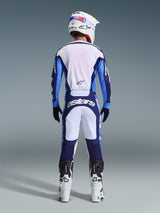 Motocross rider from behind wearing the Alpinestars 2026 Racer Riway Jersey in Ucla Blue and White, matching motocross pants with white and navy blue panels and Astars branding, white and black boots, and a white helmet, complete coordinated racing outfit for off-road performance.